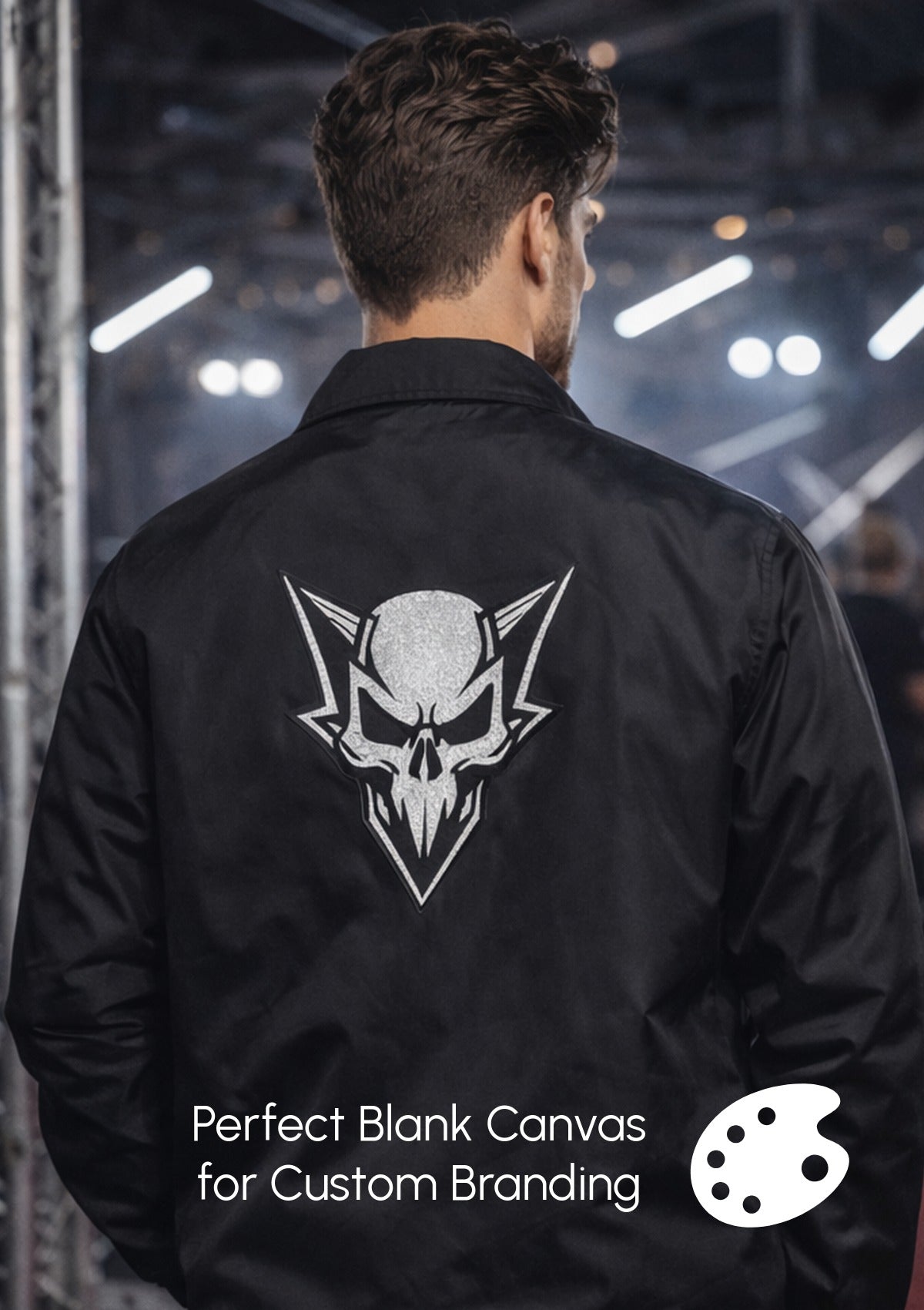 Person wearing a black jacket with a white skull logo on the back, set against a dark industrial background.